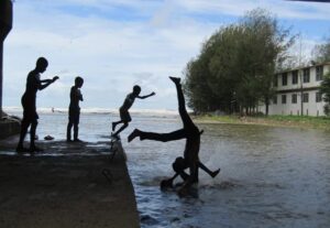 Children jumping in body of water